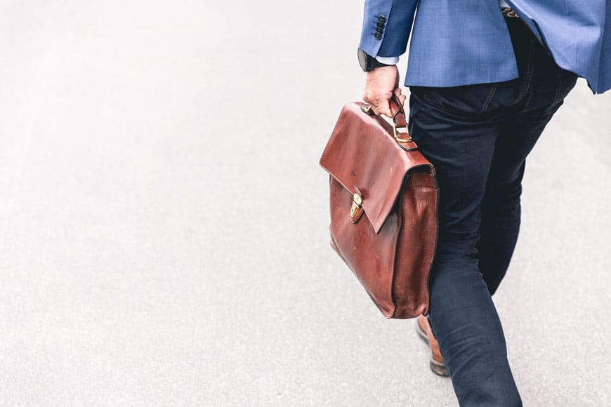 Person walking holding briefcase preparing for lawsuit